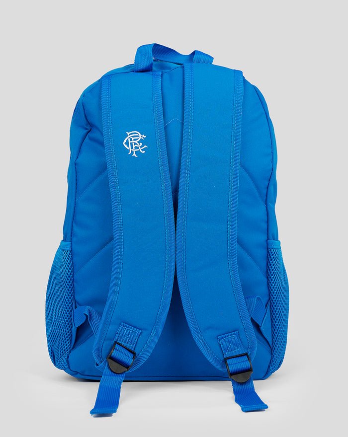 Back view of blue Rangers Core Backpack with padded shoulder straps and a logo on the left strap