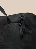 Detail of the black boot bag zipper pulls with Castore branding.