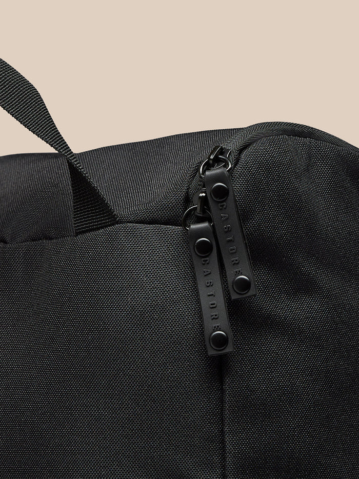 Detail of the black boot bag zipper pulls with Castore branding.