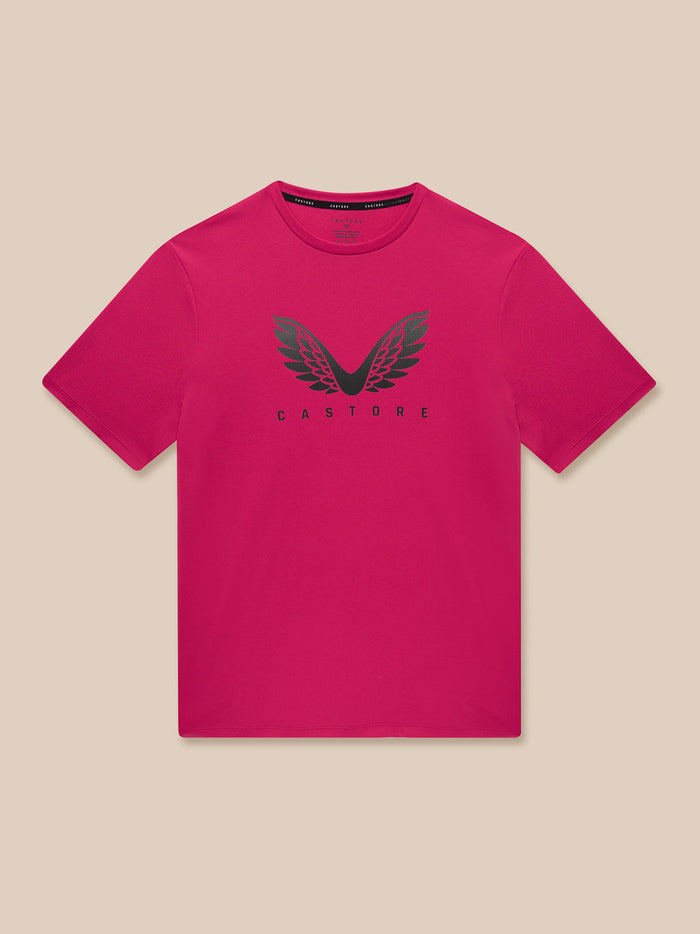 Man wearing pink ADAPT Short Sleeve Graphic T Shirt with Castore wings logo on chest