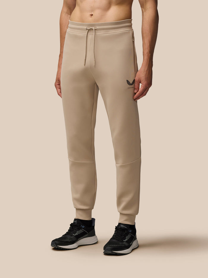 Beige mushroom Flex Lifestyle Joggers with drawstring waistband and zipped pockets; Castore logo on left leg.