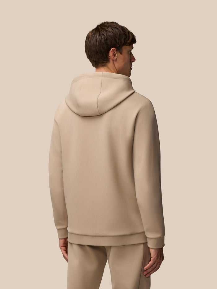 Back view of a man in mushroom Flex Lifestyle Hoodie showing the hood and clean silhouette