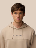 Male model wearing beige mushroom FLEX LIFESTYLE HOODIE front view with Castore branding on chest