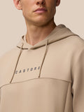 Front chest view of the beige hoodie featuring the Castore wordmark and a zipper detail.
