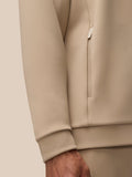 Close-up of the beige Flex Lifestyle Hoodie sleeve cuff and lower arm in knit fabric.