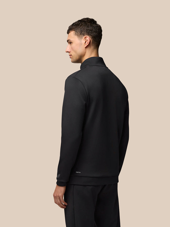 Back view of black Castore Flex Lifestyle 1/4 zip top worn by a male model