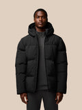 Front view of a man wearing a black Castore puffer jacket with a hood