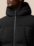 Close-up of the front zipper and Castore branding on a black puffer jacket