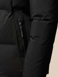 Close-up of a black puffer jacket pocket with a vertical zip and Castore branding on the zipper pull