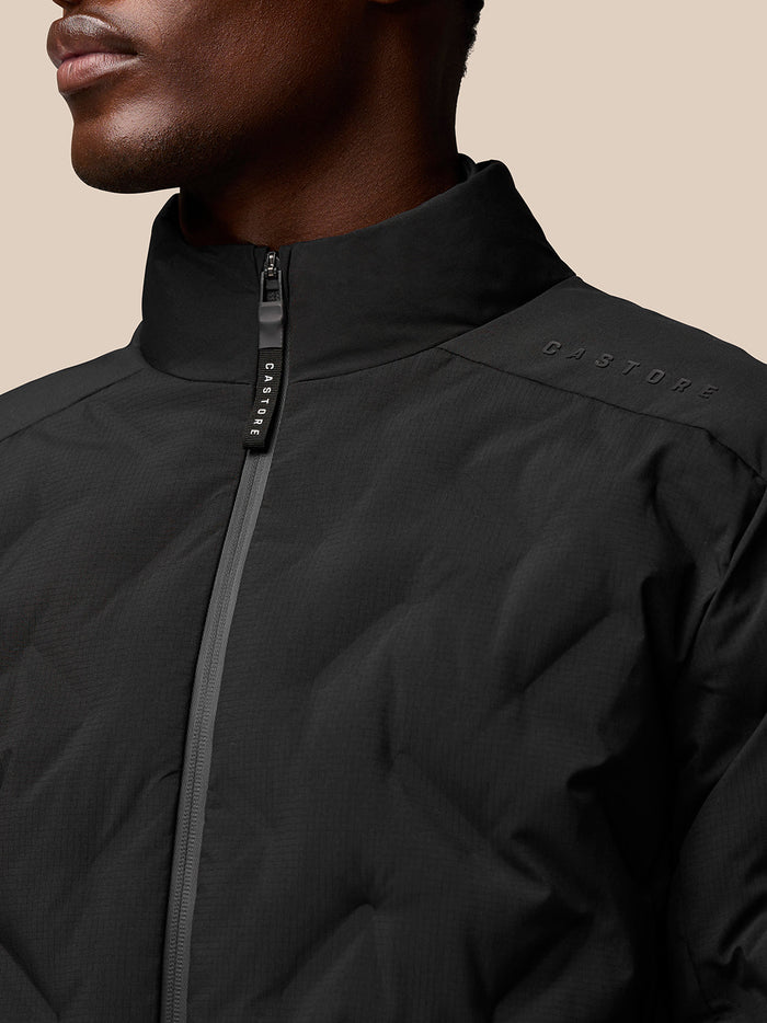 Close-up of the jacket collar and zipper with Castore branding on the shoulder