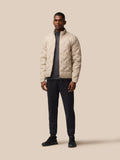 Male model wearing mushroom padded jacket full body front view with high collar and zip pockets