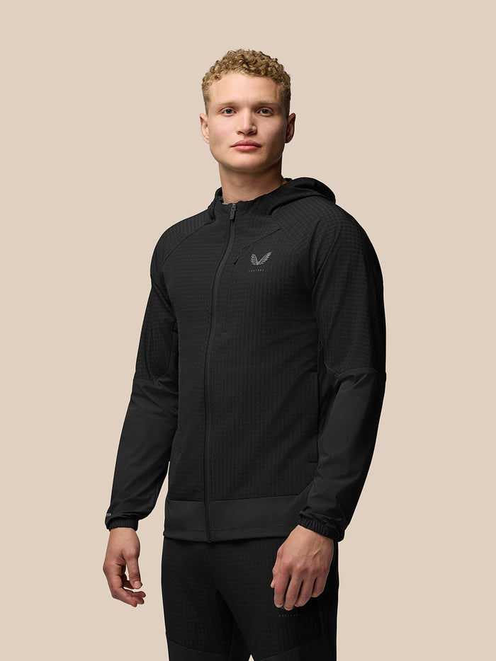 Man wearing black Flex Winterised Jacket with hood and front zipper
