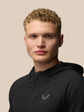 Portrait of a model wearing a black FLEX WINTERISED JACKET against a beige background