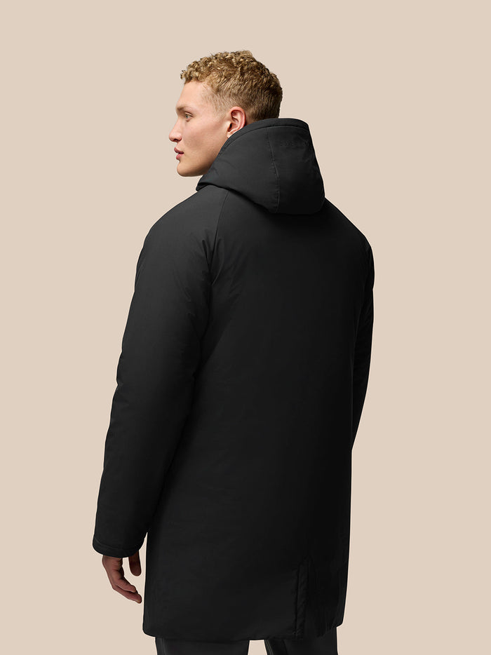 Back view of a black longline wadded jacket with hood