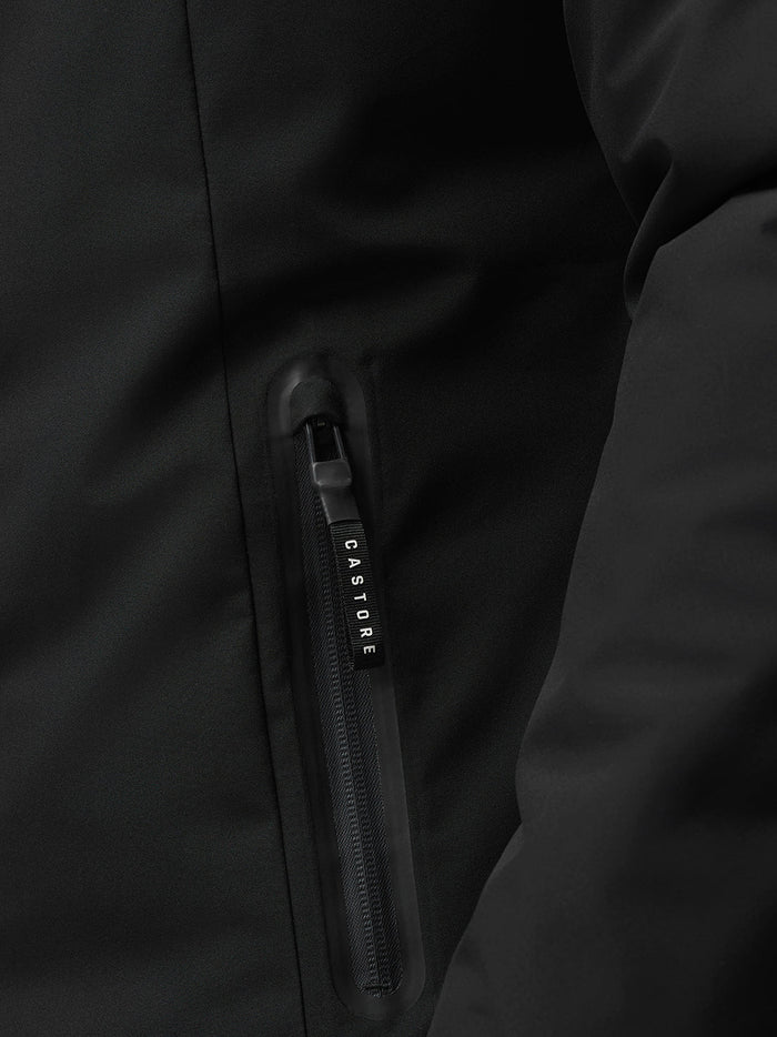 Close-up of a black jacket zipper with a CASTORE branded pull