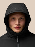 Portrait close-up of a model wearing a black hooded longline jacket