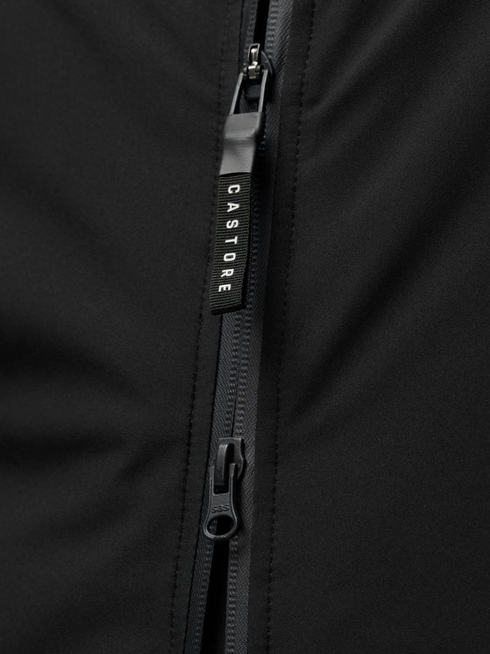 Close up of front zipper and zipper tape on black Castore longline jacket