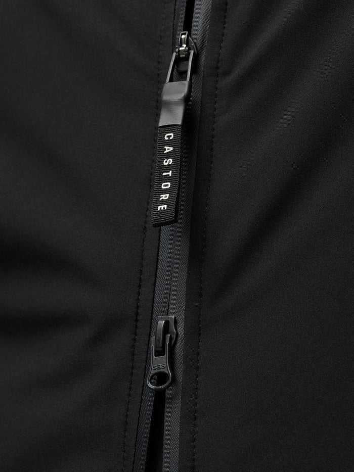 Close up of the front zipper with a CASTORE pull on the black jacket fabric.