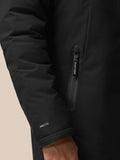 Close-up of the jacket hem with PROTEK branding visible on the fabric