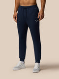 Model wearing navy Travel Lifestyle Joggers with tapered fit and Castore logo on the front.