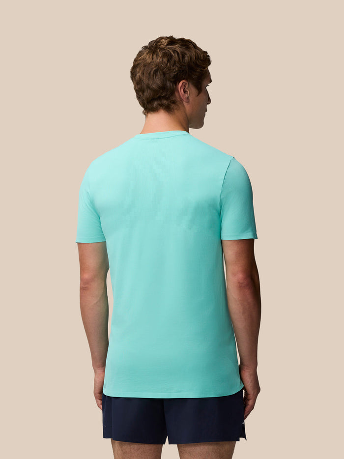 Back view of a man in light aqua Zone Training T-Shirt showing a ribbed back panel and short sleeves