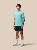 Full-body view of a man in light aqua Zone Training T-Shirt and navy shorts