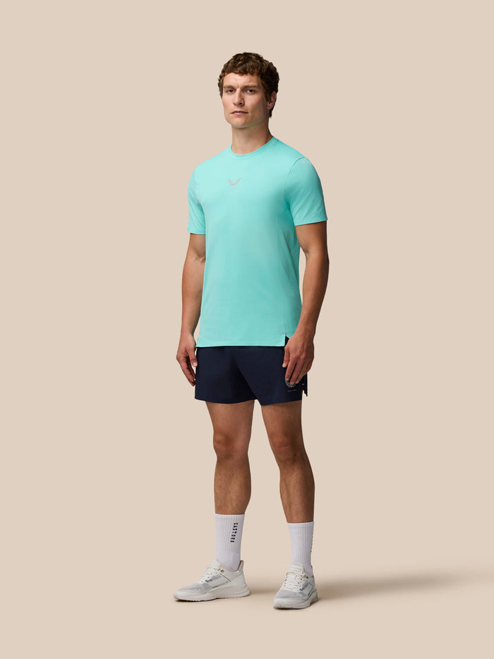 Full-body view of a man in light aqua Zone Training T-Shirt and navy shorts