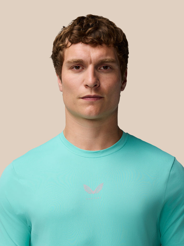Male model wearing Zone Training T-Shirt in Light Aqua with crew neck and subtle logo on chest.