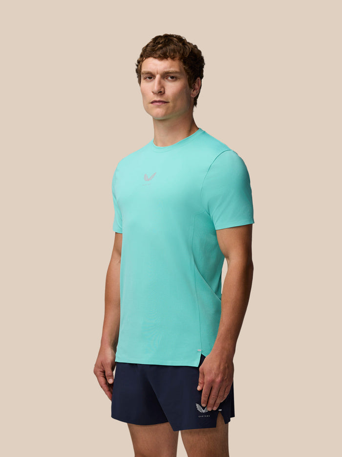 Full body view of a model wearing light aqua Zone Training T-Shirt and navy shorts.