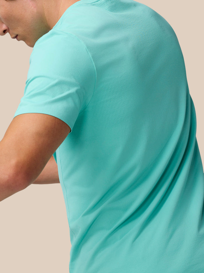 Side view of a model in light aqua Zone Training T-Shirt highlighting the relaxed fit.