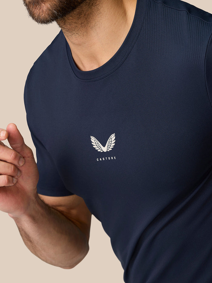 Close-up of navy Zone Training T Shirt chest logo featuring a white winged Castore emblem