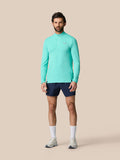 Male model wearing light aqua Zone Training 1/4 zip top with high neck and navy shorts.