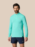 Male model wearing light aqua Zone Training quarter-zip top with high neck and long sleeves