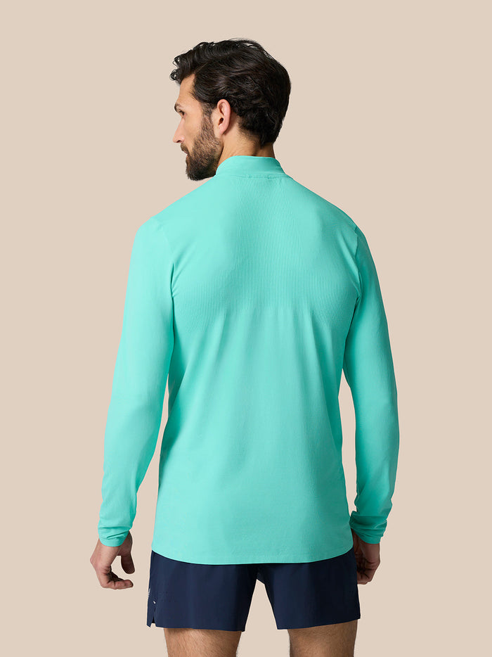 Back view of light aqua Zone Training quarter-zip top showing ribbed upper back panels and relaxed fit