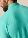 Close-up of turquoise Zone Training top showing ribbed back panel and smooth fabric