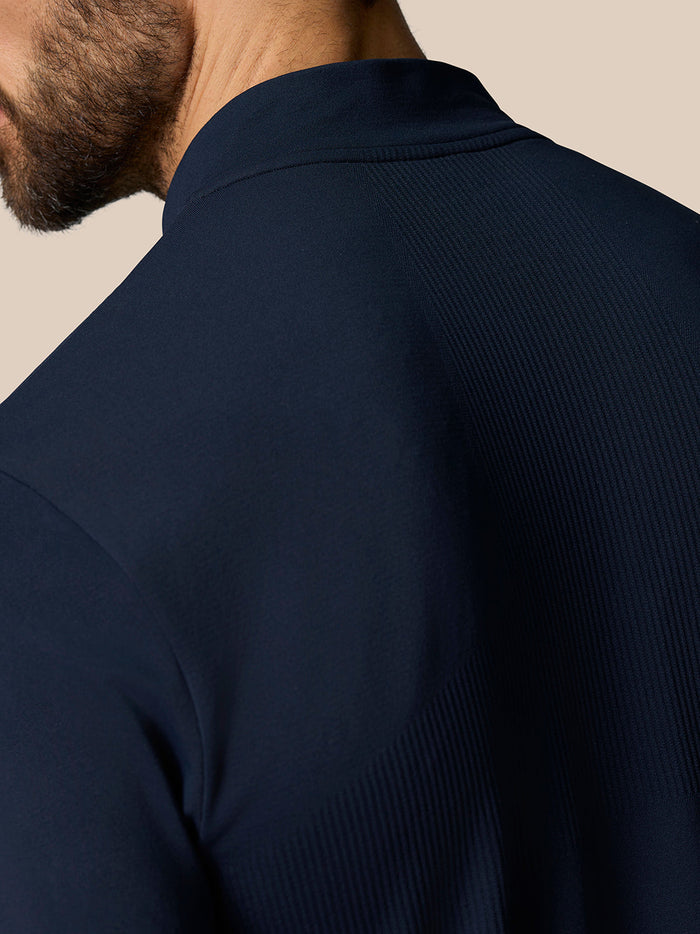 Close-up of navy Zone Training top shoulder and upper back showing ribbed knit panels