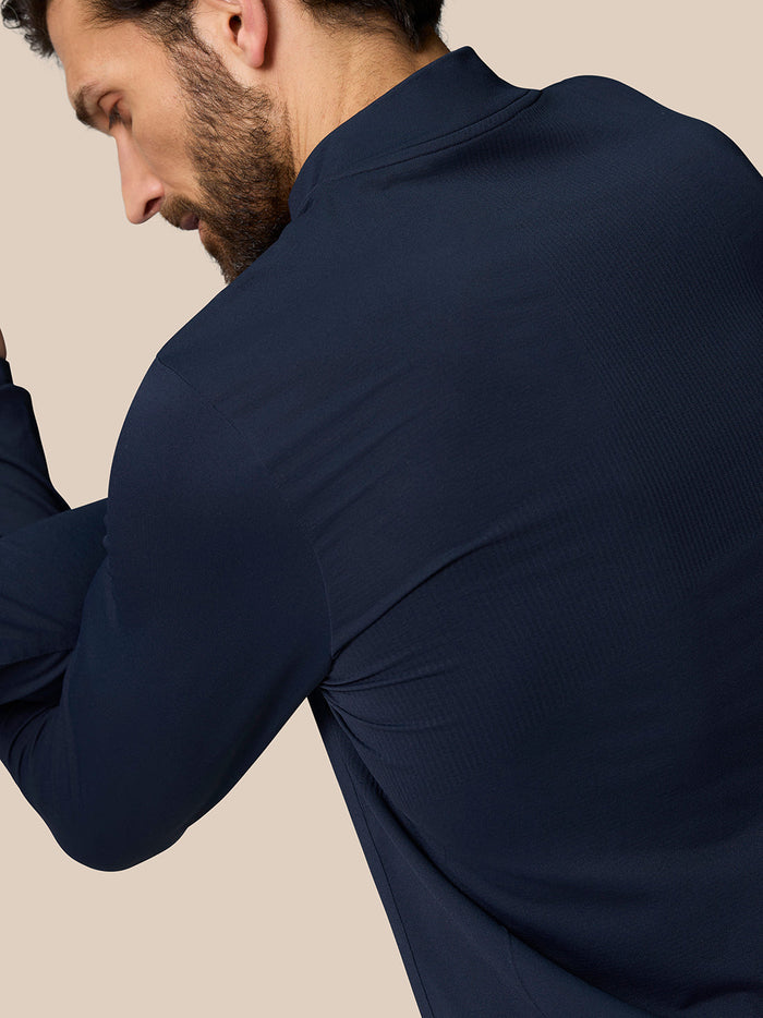 Back view of navy Zone Training 1/4 zip top highlighting ribbing and engineered knit fabric