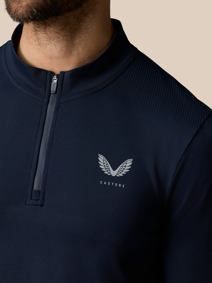 Close-up of navy Zone Training 1/4 Zip Top with front zipper and Castore logo on chest