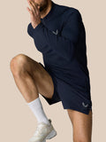 Male model wearing navy Zone Training 1/4 zip top with high neck and reflective branding