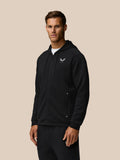 Man wearing black travel lifestyle zip hoodie with hood down and Castore logo on chest