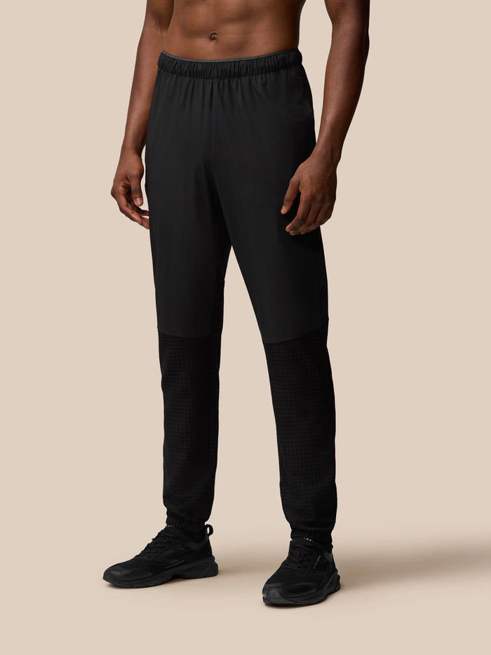 Black Flex Winterised woven joggers on a model with elastic waistband and textured lower leg panels
