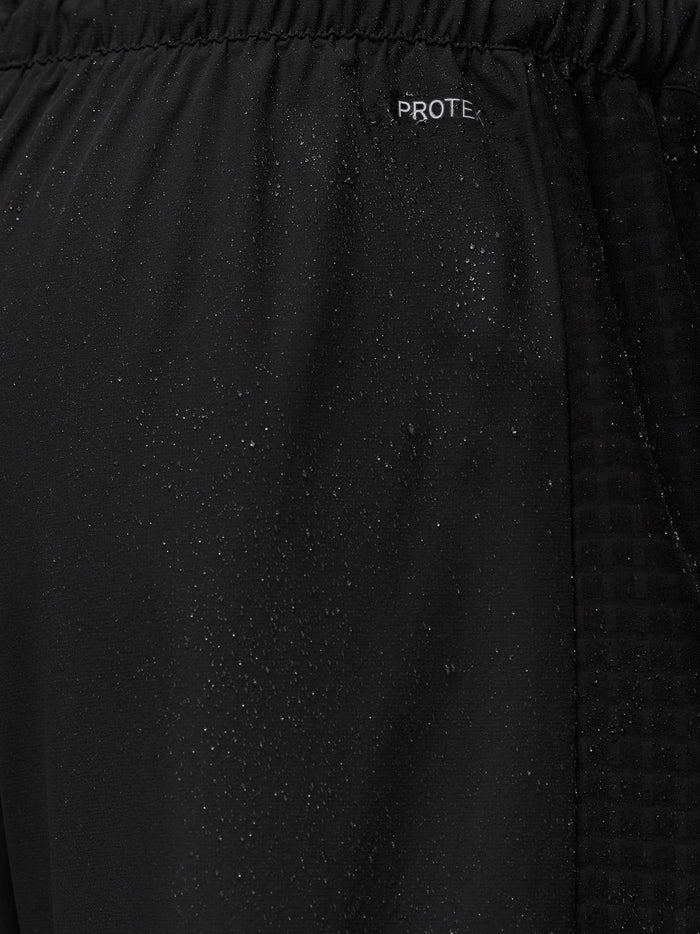 Close up of black PROTEK fabric with the PROTEK logo near the waistband