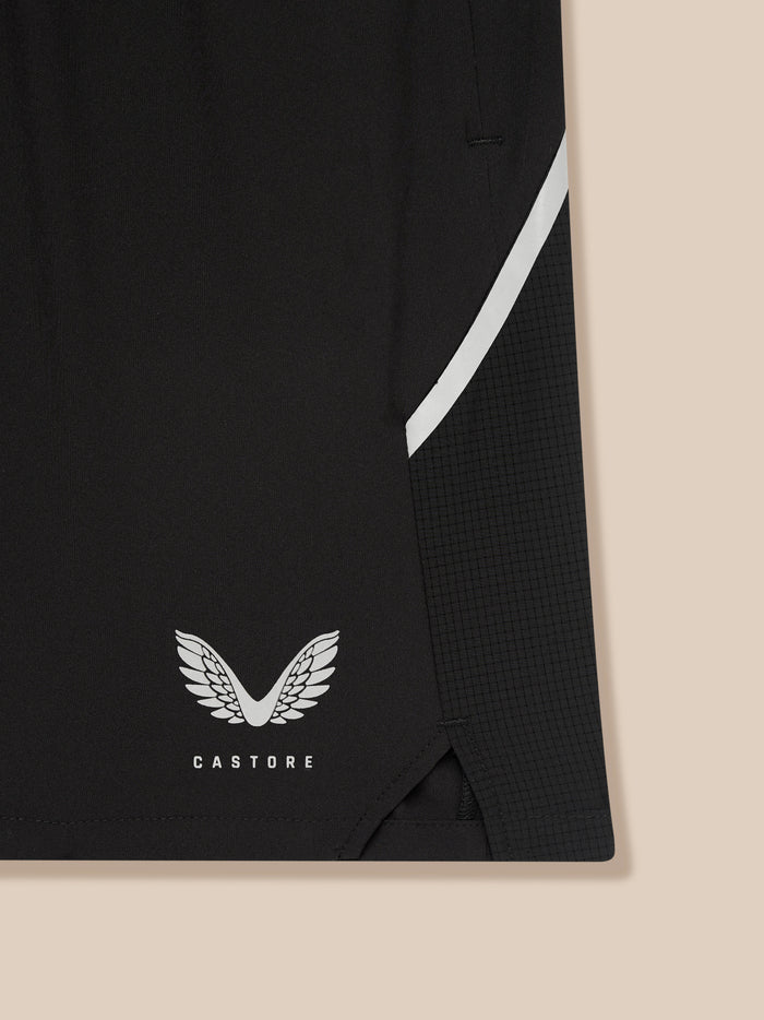 Close-up of black shorts with a white diagonal stripe and Castore wing logo near the hem.