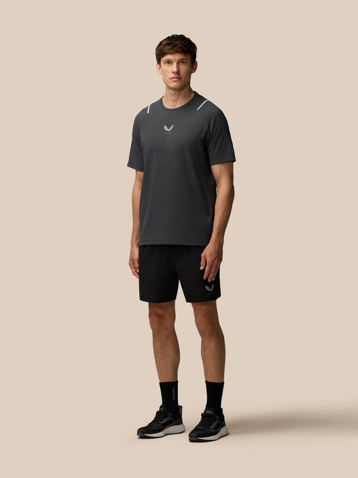 Front view of a man in Apex Training shorts with a logo on the left leg