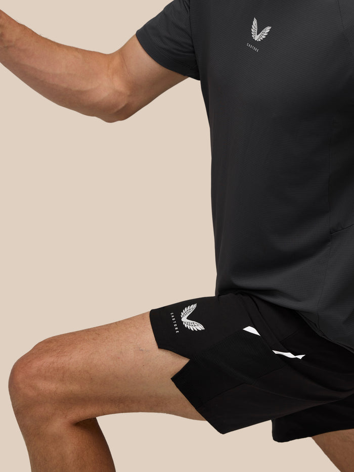 Close up of black Apex shorts showing Castore logo at the hem