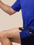 Close-up of a model wearing a royal blue athletic top with textured fabric.
