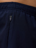 Close-up of the navy waistband and zipper pull on Apex 6 inch shorts.