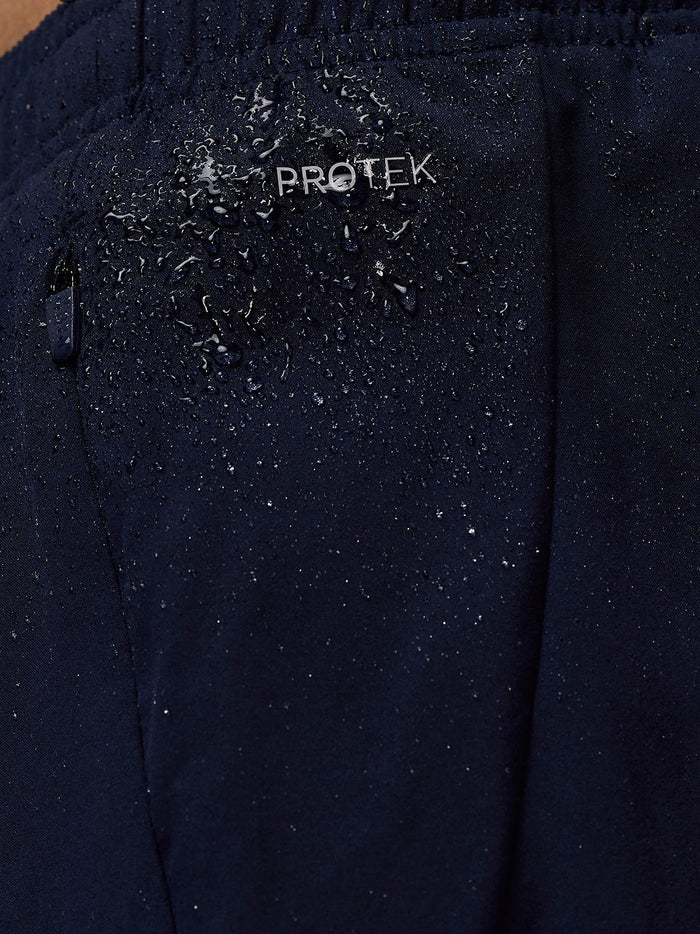 Close up of navy Apex shorts fabric showing ProTek water resistance with droplets on the material