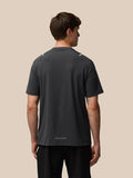 Back view of a man in a dark Apex Training T-shirt with Castore branding at the hem.