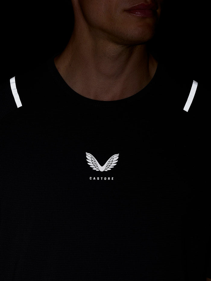 Close-up of Castore logo on chest of black Apex Training T Shirt with reflective shoulder stripes.